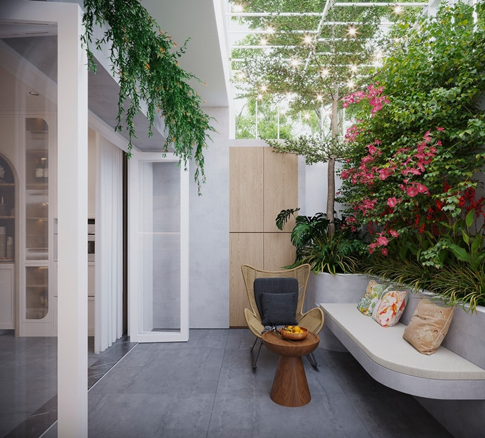 Để giảm bớt ánh nắng trực tiếp hướng Tây, căn nhà được tạo một khoảng lùi với mái hiên rộng và phủ một hệ cây xanh mát mẻ. Ảnh: SBS House