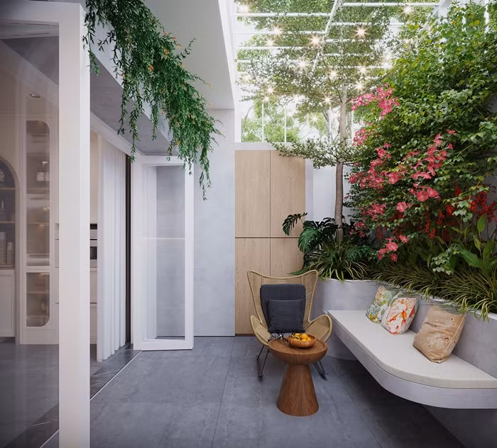 Để giảm bớt ánh nắng trực tiếp hướng Tây, căn nhà được tạo một khoảng lùi với mái hiên rộng và phủ một hệ cây xanh mát mẻ. Ảnh: SBS House