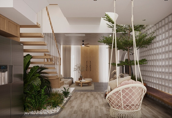 Khoảng trống dưới cầu thang được tận dụng trồng các loại cây, tạo thành góc tiểu cảnh xanh mát. Ảnh: SBS House