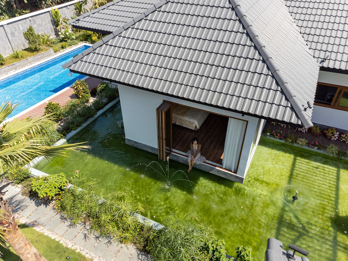 Tọa lạc tại thị xã Trảng Bàng, huyện Tây Ninh, ngôi nhà vườn có tổng diện tích 1300m² này là một tác phẩm kiến trúc độc đáo, kết hợp hài hòa giữa yếu tố hiện đại và truyền thống. Ảnh: Story Architecture