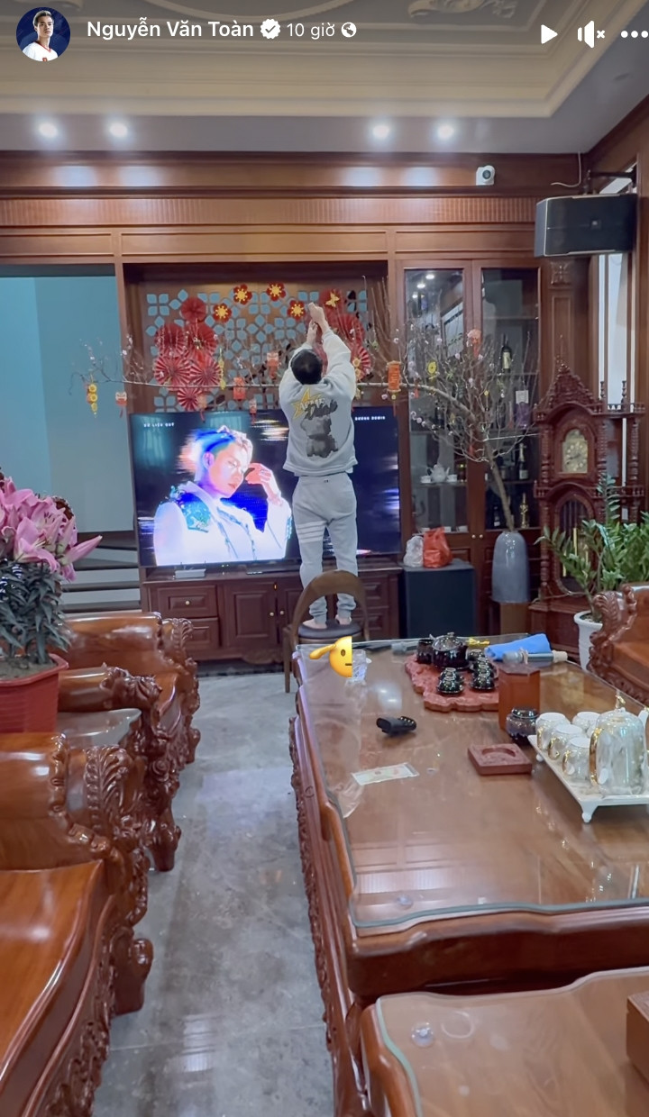 Trong phòng khách, Văn Toàn trang trì bằng cành đào dáng huyền lớn kết hợp dây tài lộc cùng đèn lồng rực rỡ. Ảnh: FB Nguyễn Văn Toàn