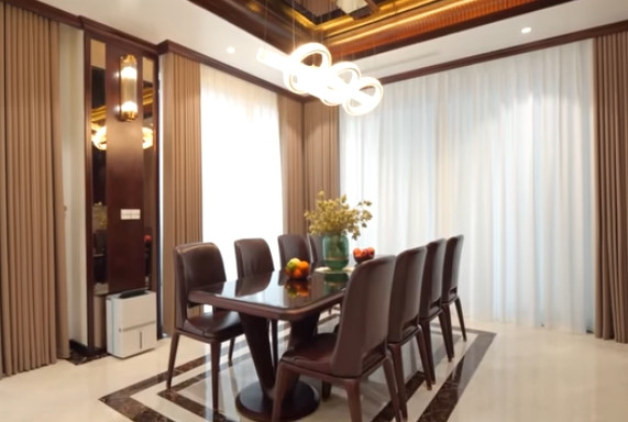 Bàn ăn lớn bằng gỗ óc chó kết hợp da nhập khẩu đủ chỗ cho 8 người. Ảnh chụp màn hình NhaF