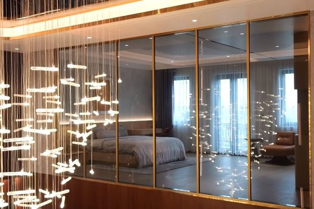 Phòng ngủ phụ sở hữu tầm view siêu đẹp nhìn ra khoảng thông tầng và đón ánh sáng từ ban công. Ảnh chụp màn hình