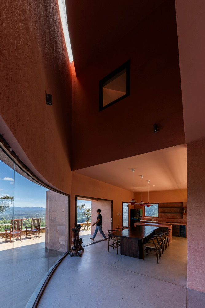 Đá tự nhiên, biểu tượng của vùng đất Lâm Đồng, được chọn làm bậc tam cấp, hài hòa với sắc đỏ ấm của tường và màu xám trầm từ đá mài cầu thang. Ảnh: Hiroyuki Oki