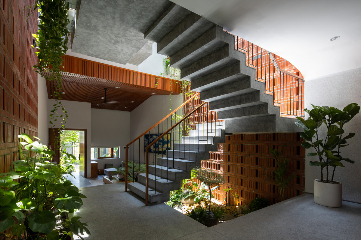 Không gian lệch tầng kết hợp việc đảo vế thang giúp tạo nên các khoảng giếng trời lớn nhỏ, các mảng cây xanh len lỏi trên mọi tầng bậc của không gian. Ảnh: Hoàng Lê