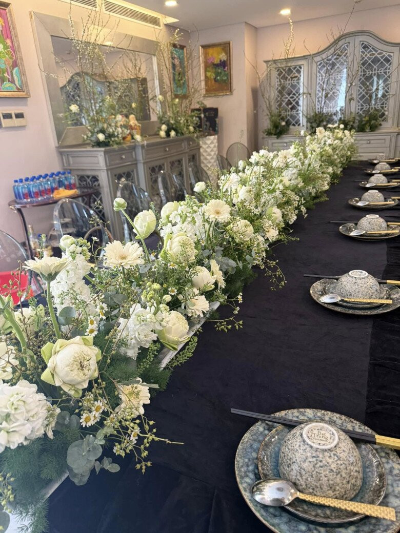 Bàn ăn dài được trang trí bằng dải hoa trắng. Ảnh: FBNV