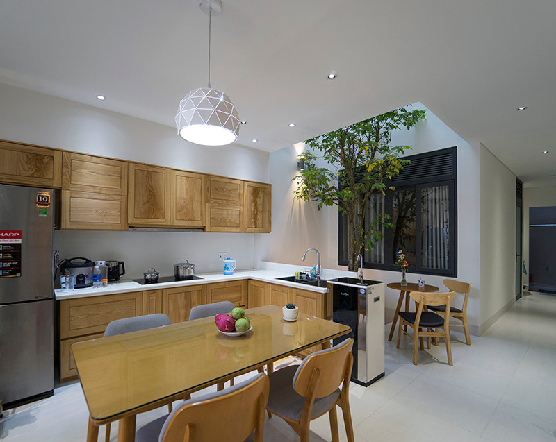 Phòng bếp sử dụng nội thất gỗ chủ đạo. Ảnh: QPS House