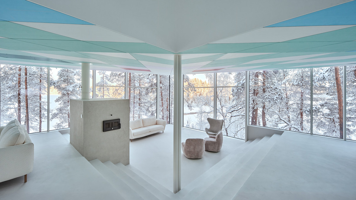 Phòng khách nằm bên dưới cầu thang, tách biệt với khu bếp - ăn nhưng vẫn dễ dàng tương tác với các thành viên trong gia đình. Ảnh: Marc Goodwin/Archmospheres