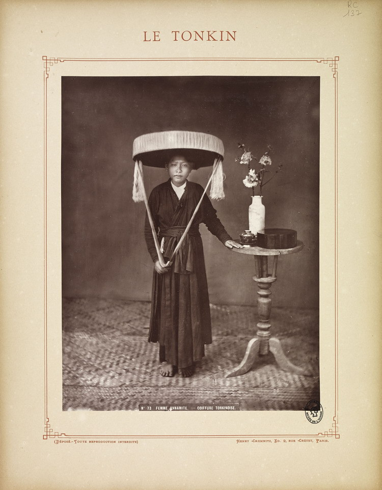 Một phụ nữ Bắc Bộ trong trang phục truyền thống, gồm áo tứ thân và nón quai thao.