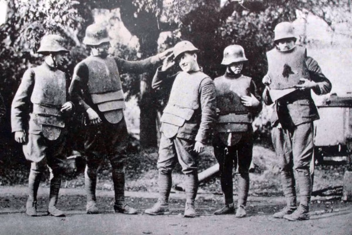 Trong Chiến tranh thế giới 1, hàng chục tấn bom đạn được sử dụng. Để giảm thiểu thương vong cho binh sĩ, nhiều nước đã nghiên cứu, thử nghiệm áo chống đạn. Trong ảnh là những lính Mỹ thử nghiệm áo chống đạn năm 1918.