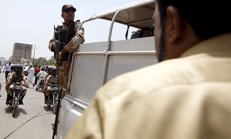 Một sĩ quan cảnh sát đang đứng quan sát từ một chiếc xe tải bên ngoài một bệnh viện sau cuộc tấn công ngày 13/5.