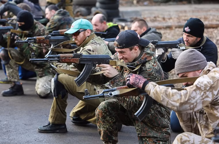 Các tình nguyện viên được dạy cách bắn súng trúng mục tiêu.