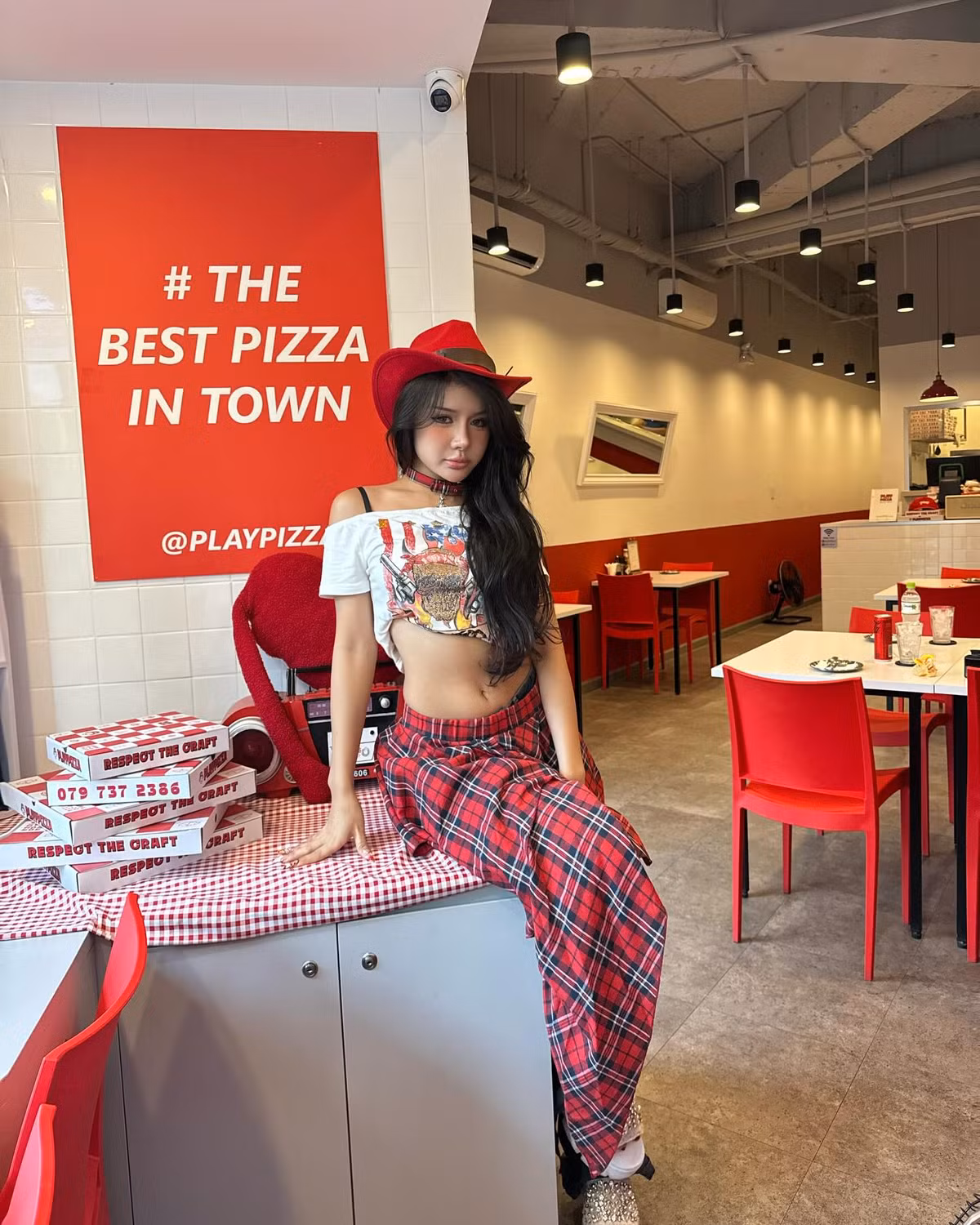 Lối trang điểm sắc sảo với đôi mắt eyeliner đậm, lens sáng và môi hồng cam căng mọng càng khiến gương mặt Xuân Ca thêm phần hút ánh nhìn. Cô khéo léo kết hợp cùng choker plaid phong cách punk - một điểm nhấn vừa ngổ ngáo vừa gợi cảm - giúp tổng thể thêm phần hoàn chỉnh.