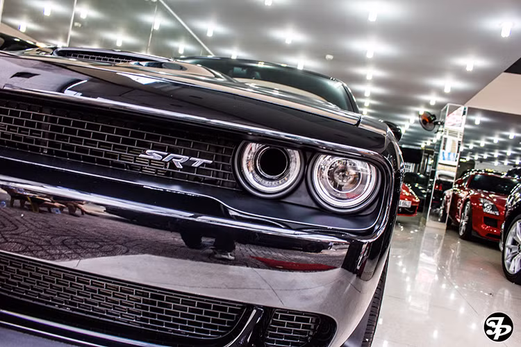 Đầu xe với lưới tản nhiệt chia đôi với thiết kế dạng ô nhỏ xen kẽ xếp zíc zắc được nẹp viền bằng kim loại mạ crom sáng bóng, ở phần trên lưới tản nhiệt xuất hiện logo của phiên bản SRT nhà Dodge Challenger.