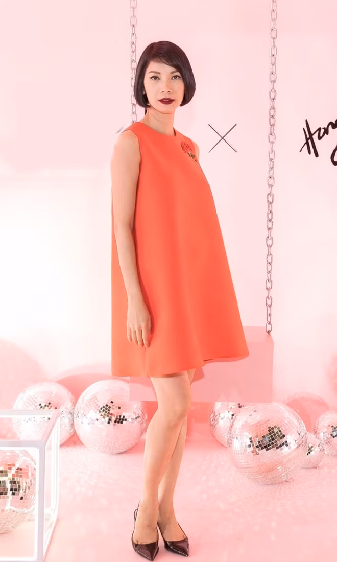 Siêu mẫu Xuân Lan đơn giản với chiếc váy dáng suôn màu đỏ cam nổi bật.