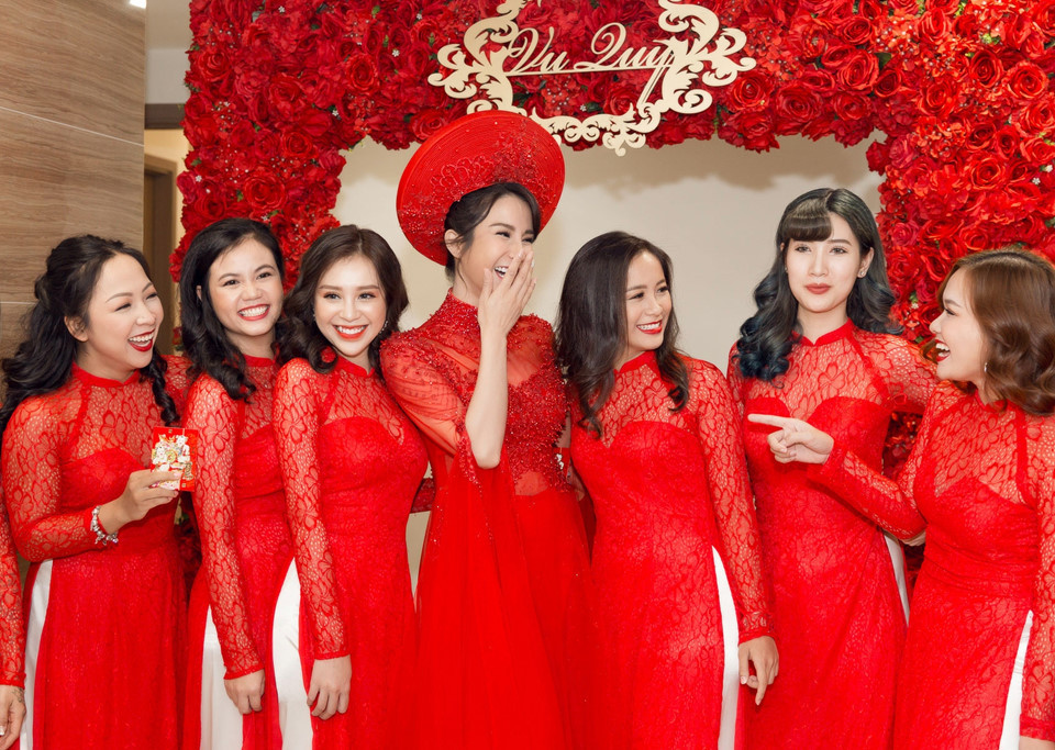 Cô dâu xinh đẹp bên dàn phù dâu. Họ đều diện áo dài đỏ "ton sur ton" với gam màu của không gian lễ đón dâu.