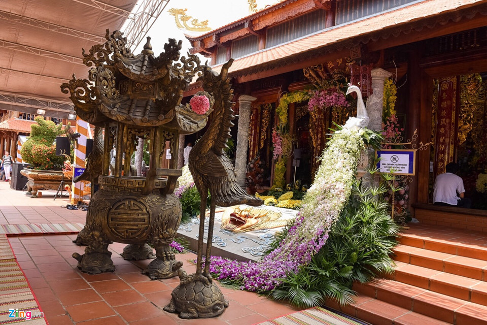 Cổng vào điện chính được danh hài Hoài Linh trang trí cầu kỳ. Bên lư đồng, chim hạc, hai bên lối vào điện còn có chim công được kết từ hoa lan.