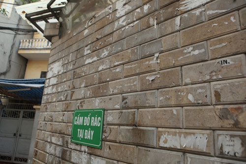 Tường nhà của người dân vẫn còn nhiều dấu vết của tờ rơi quảng cáo sau khi được bóc đi.