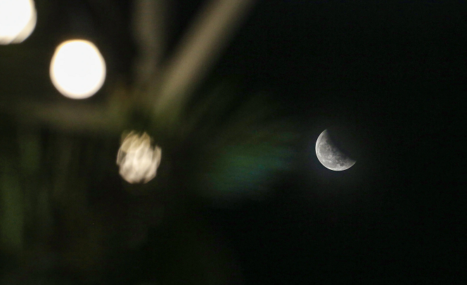 Tại TP HCM, thời tiết xấu cũng ảnh hưởng khá nhiều tới việc quan sát nguyệt thực của người dân. Khoảng 19h trăng mới xuất hiện. (Nguồn: Dân trí)