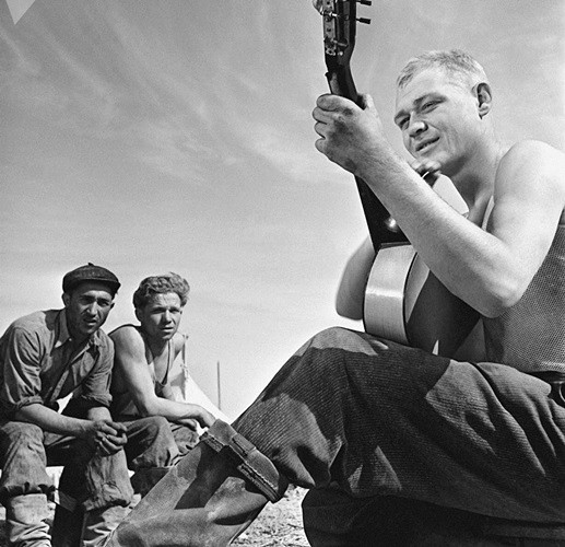 Phút thư giãn với guitar trong giờ nghỉ trưa của một nhóm đoàn viên thanh niên đi lao động, vào năm 1959. Tổ chức Komsomol cuối cùng bị giải thể vào tháng 9/1991 trong bối cảnh có nhiều biến động lớn bên trong đất nước Xô viết.