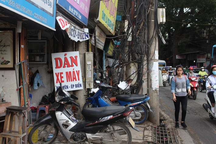 Cột điện trên phố Đê La Thành choán hết phần đường của người đi bộ. Ảnh: Hoàng Mạnh.
