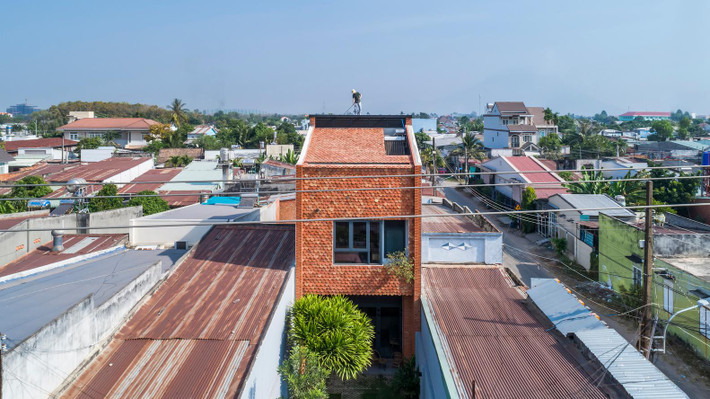 Ngôi nhà này sử dụng ngói vảy cá màu đỏ để lát toàn bộ mặt tiền và mái (trừ phần cửa sổ lớn tại tầng 2 và giếng trời ở tầng thượng). Thiết kế tuy đơn giản nhưng lại tạo ra sự độc đáo và mát mẻ cho ngôi nhà vì ngói được coi là vật liệu cách nhiệt vô cùng tốt từ xưa đến nay.