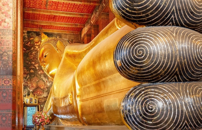 4. Đền thờ Phật Nằm: Nằm ở Bangkok, đền Wat Pho nổi tiếng có bức tượng Phật nằm khổng lồ. Đây là một trong những ngôi đền lớn nhất ở Bangkok và cũng là một trong những ngôi chùa cổ nhất, được xây dựng gần 200 năm trước khi Bangkok trở thành thủ đô của Thái Lan. Wat Pho được biết đến không chỉ có tượng Phật Nằm lớn nhất Thái Lan mà còn nổi tiếng có nhiều tượng Phật nhất Thái Lan. Tượng Phật Nằm mạ vàng dài 46 m và cao 15 m, mô phỏng cảnh Đức Phật nhập Niết bàn. Mắt và chân của bức tượng được trang trí bằng xà cừ chạm khắc, còn lòng bàn chân thể hiện 108 tướng tốt của Đức Phật