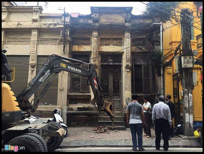 Chiều ngày 25/3, các lực lượng chức năng phường Trúc Bạch cho xe chuyên dụng phá bậc tam cấp của ngôi nhà. Ảnh: Mai Kỳ.