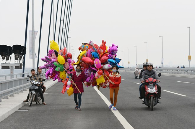 Lực lượng bán rong bóng bay lên cầu chào mời khách hàng như ngày Tết.