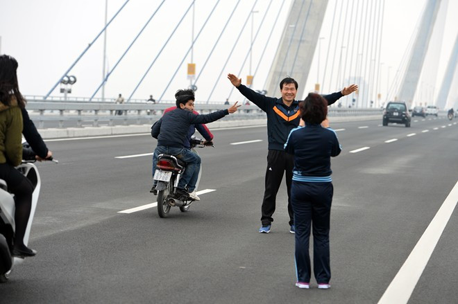 Nhiều người đứng hẳn ra làn ô tô giang tay tạo dáng.
