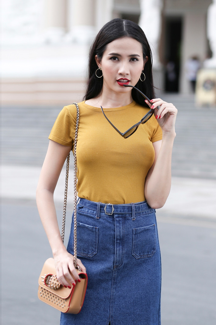Chân váy denim với chi tiết xẻ cao ấn tượng được Phan Thị Mơ kết hợp với một chiếc áo phông màu vàng tạo nên sự hài hòa cho bộ trang phục.
