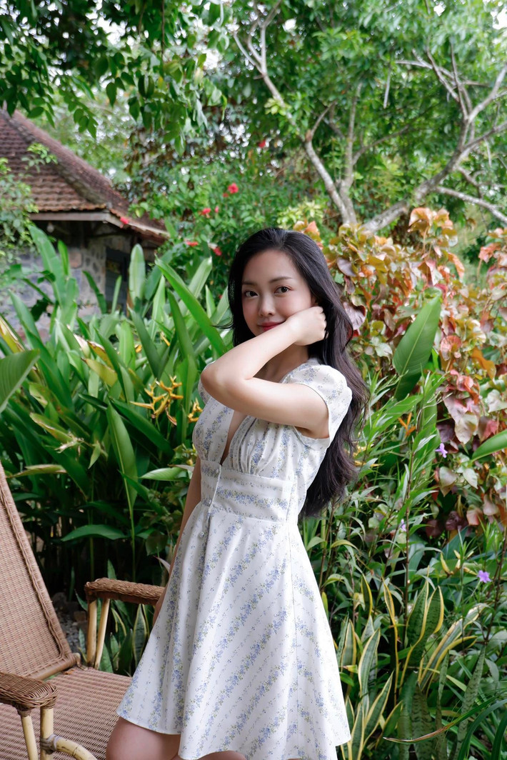 Trong bộ ảnh, Mai Hà Trang diện chiếc váy trắng tinh khôi, với nền họa tiết hoa nhí nhẹ nhàng, thiết kế cổ V tinh tế, tôn lên bờ vai thon gọn. (Ảnh: FBNV)