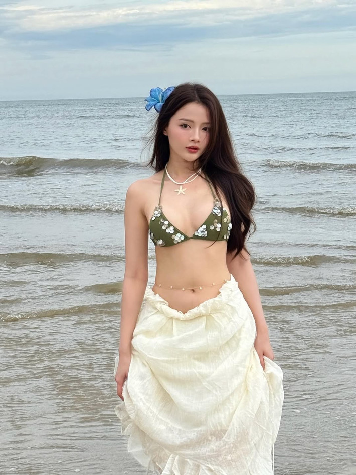 Chiếc bikini màu xanh olive với thiết kế dây buộc mảnh mai làm nổi bật làn da trắng mịn và những đường cong gợi cảm của cô. (Ảnh: IGNV)