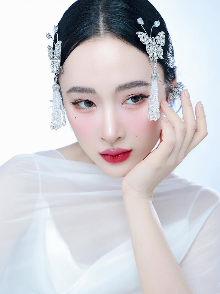 Trong bộ ảnh, người đẹp sinh năm 1995 để tóc dài, diện váy trắng và tạo dáng uyển chuyển nhẹ nhàng.