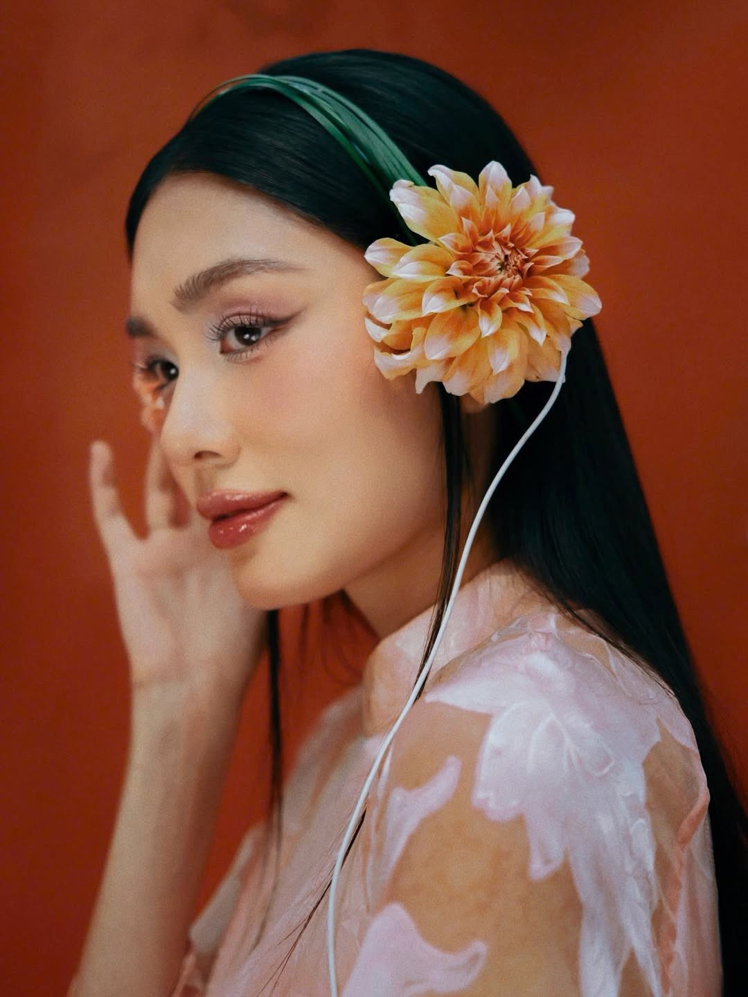 Lần này, "nàng tiểu thư" lựa chọn áo dài mang sắc hồng phấn ngọt ngào. Điểm độc đáo nằm ở chất liệu vải xuyên thấu có họa tiết hoa dập nổi 3D, tạo hiệu ứng mờ ảo và mềm mại mỗi khi chuyển động. (Ảnh: IGNV)