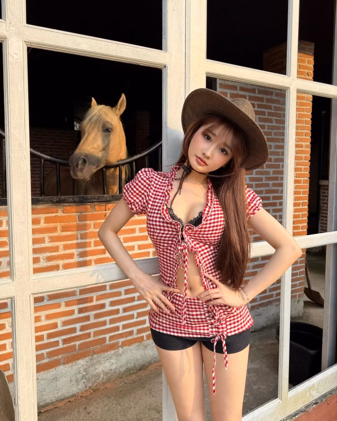 Điểm nhấn của bộ trang phục chính là chiếc áo sơ mi caro đỏ trắng được thiết kế theo kiểu croptop thắt dây, giúp cô nàng khoe khéo vòng eo con kiến không chút mỡ thừa. (Ảnh: IGNV)