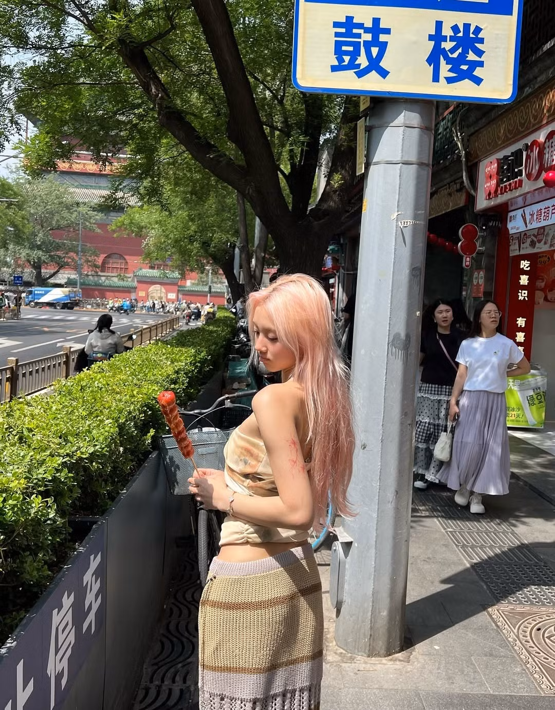 Đặc biệt, trong một số khoảnh khắc, Vyvan Le tạo dáng với xiên kẹo hồ lô – món ăn vặt truyền thống nổi tiếng, càng làm tăng thêm sự giao thoa độc đáo giữa nét đẹp hiện đại của cô và bối cảnh truyền thống cổ kính.(Ảnh: IGNV)