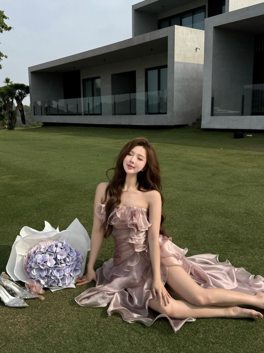 Không cần bối cảnh cầu kỳ, Trần Linh Hương chọn không gian là một thảm cỏ rộng lớn bên cạnh kiến trúc hiện đại tối giản. (Ảnh: IGNV)