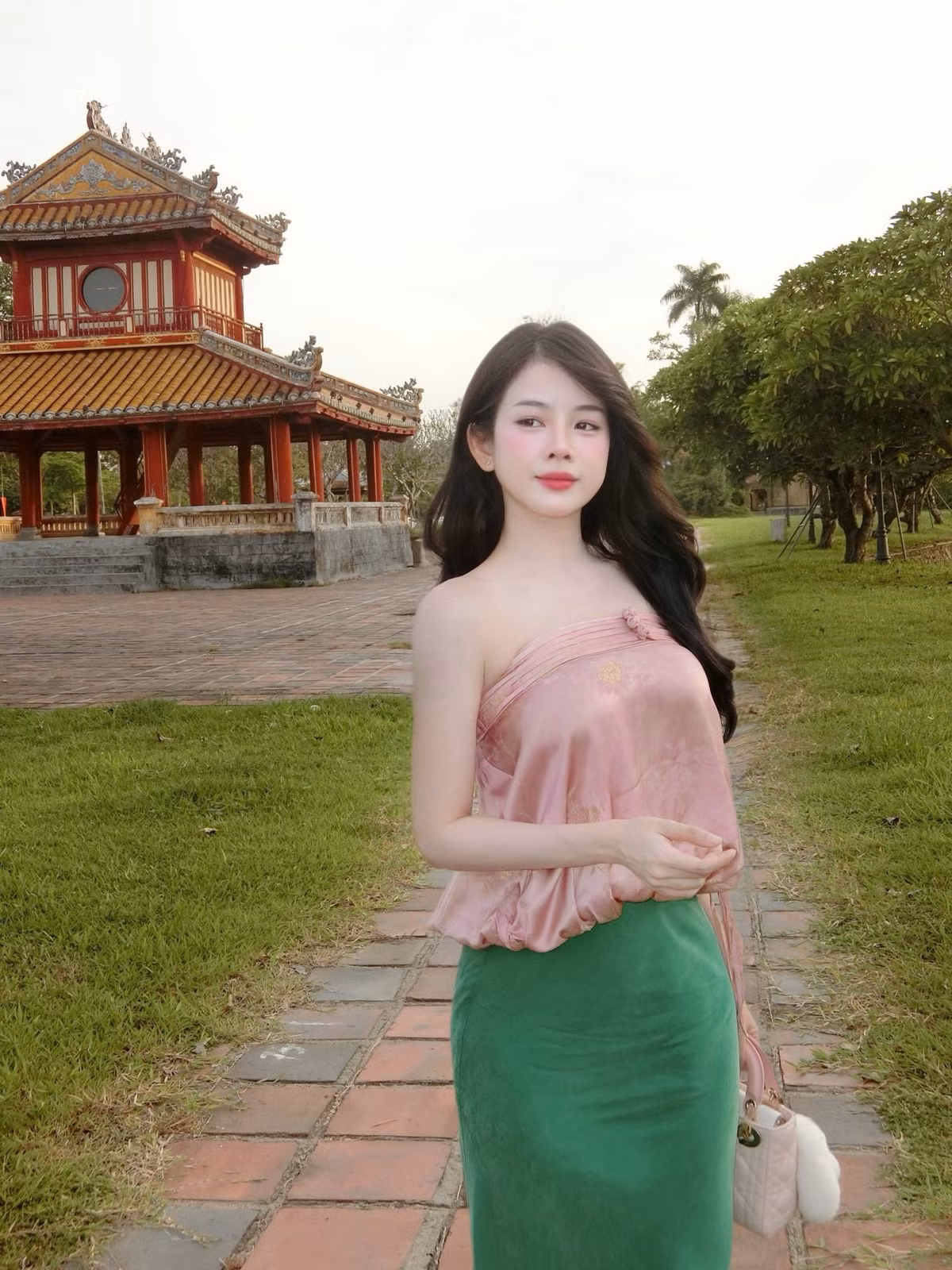 Trong những bức ảnh mới được đăng tải, DJ Mie xuất hiện với chiếc áo quây màu hồng phấn, kết hợp cùng chân váy dài màu xanh lá cây, tạo nên sự hài hòa, dịu dàng nhưng không kém phần thanh lịch.