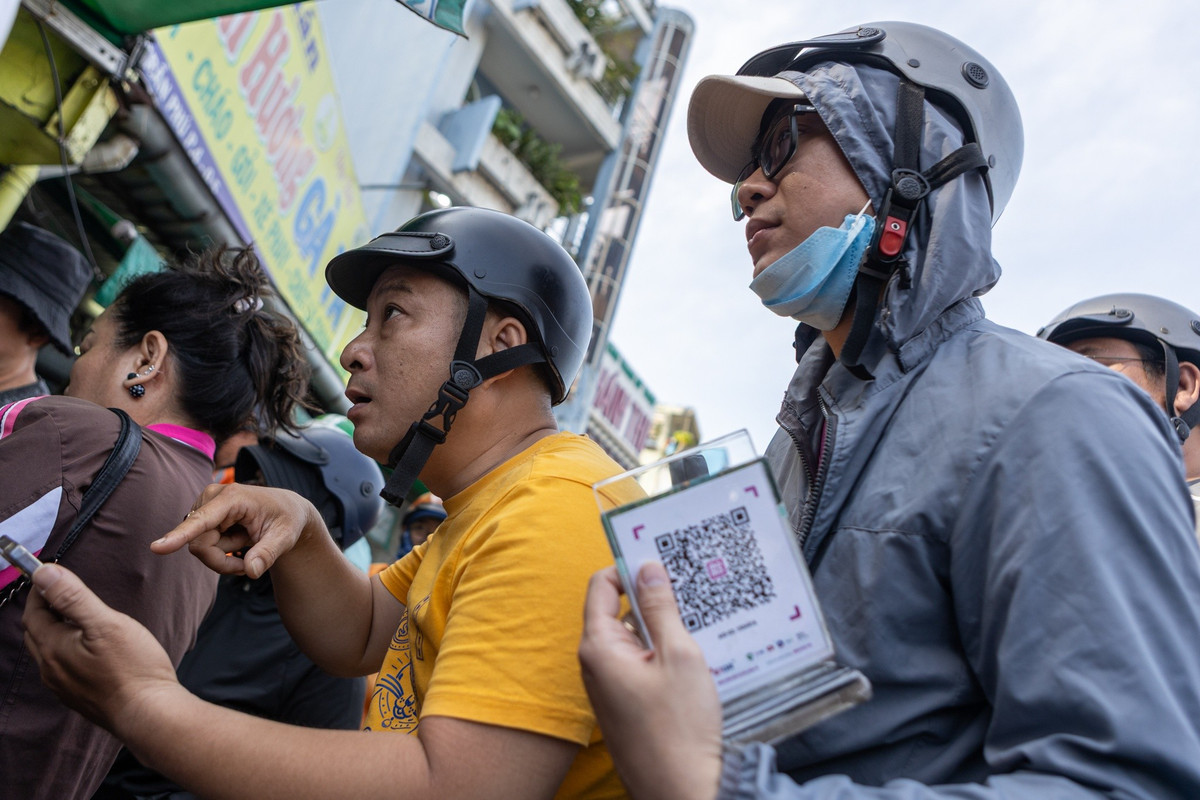 Anh Phúc Hồng (áo vàng, ngụ phường Chợ Lớn) cho biết đã mua gà ở đây hơn 5 năm. Anh đến lúc 8h45 và đợi hơn 40 phút mới nhận được gà. "Nhà tôi muốn mâm cúng thật chỉn chu, đợi lâu chút cũng không sao", anh Hồng nói.