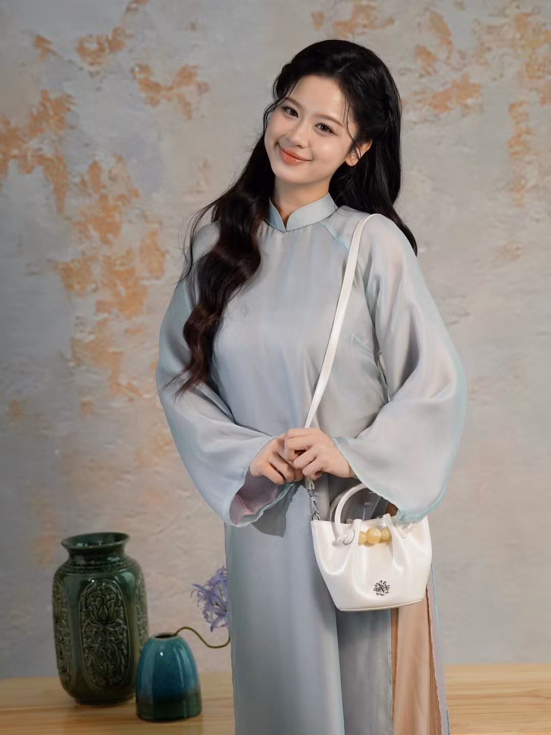 Mái tóc đen dài uốn sóng nhẹ nhàng được búi nửa đầu giúp tôn lên gương mặt thanh tú và khí chất sang trọng. (Ảnh: IGNV)