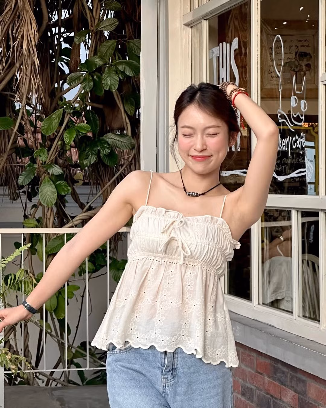 Thiết kế áo có phần ngực smock đặc trưng với dây rút tạo độ bồng bềnh duyên dáng, kết hợp với chiếc quần jean cơ bản tạo nên sự cân bằng hoàn hảo giữa ngọt ngào và năng động. (Ảnh: IGNV)