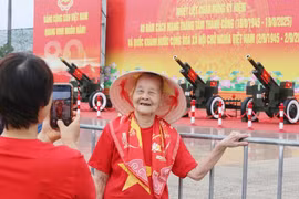 Cụ bà 99 tuổi phấn khởi chụp ảnh cùng pháo lễ ở Mỹ Đình