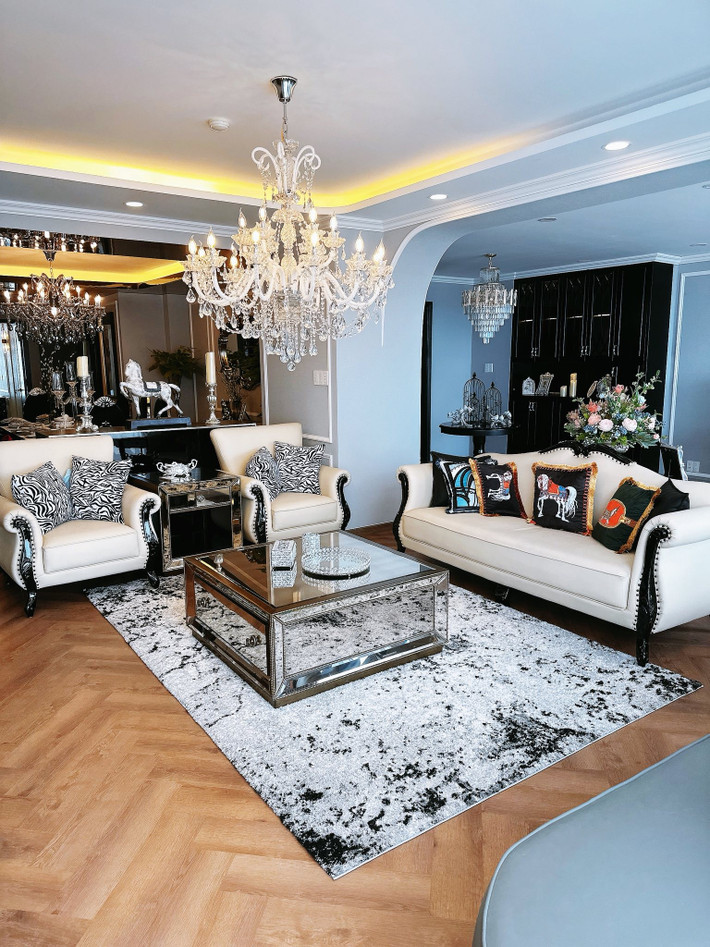Phòng khách nổi bật với bộ sofa trắng và đèn chùm lớn. Ảnh: FB Nguyên Vũ