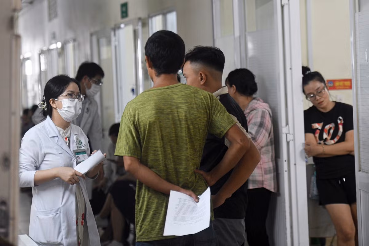 Tại hành lang khoa, người nhà bệnh nhân đứng chờ nghe thông tin từ bác sĩ điều trị. Không khí chùng xuống khi nữ bác sĩ trao đổi kết quả và hướng dẫn quy trình can thiệp tiếp theo. Phía sau, nhiều người khác vẫn thấp thỏm chờ tin người thân trong phòng cấp cứu. Mỗi ca bệnh là một cuộc đua với thời gian, và hành lang này thành nơi chất chứa xen lẫn lo âu và hy vọng.