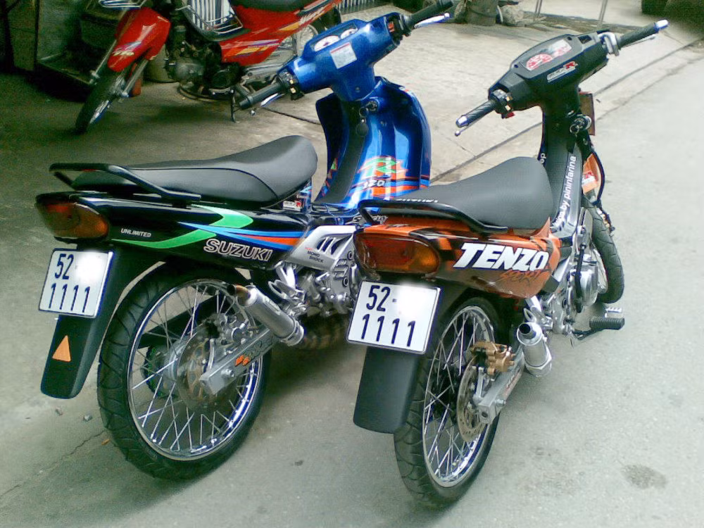 Dòng xe đình đám một thời Suzuki Sport vẫn là nguồn cảm hứng vô tận của những tín đồ mê xe độ. Bộ đôi Xì po này của dân chơi Sài Gòn không chỉ hút mắt với vô số đồ chơi khủng hội tụ trên xe mà còn bởi biển số tứ quý 1 "4 cây gậy khủng bố" của chúng.