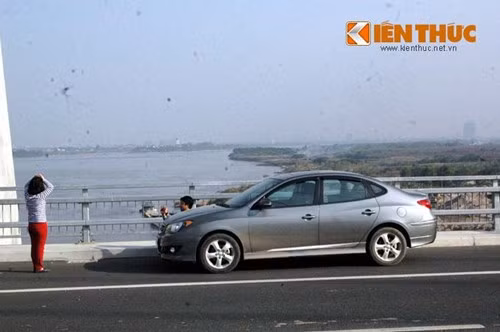 Không chỉ xe máy, ô tô cũng thản nhiên dừng ở cầu, chủ nhân của xe tạo dáng chụp ảnh, mặc kệ nguy hiểm cho mọi người tham gia giao thông.