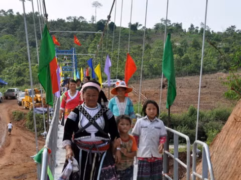 Thầy trò và người dân vui mừng, phấn khởi qua suối bằng cầu mới. (Ảnh Tuổi trẻ).