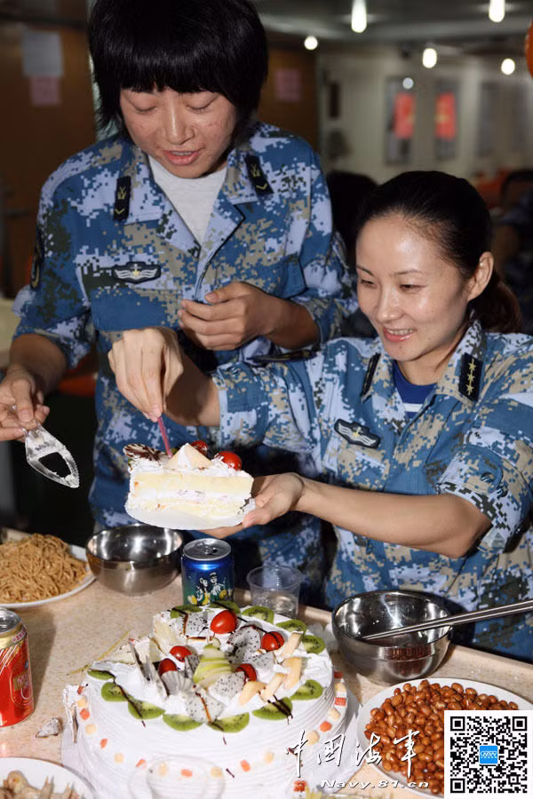 Wu Tong (người đứng), 19 tuổi, là nữ thủy quân lục chiến trẻ nhất trên tàu vận tải đổ bộ. Cô gái cắt bánh ngọt mừng sinh nhật với đồng đội trên tàu.