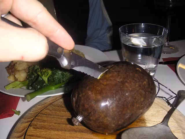  1. Haggis – Scotland: Haggis là món ăn được làm từ gan, tim và phổi cừu băm nhỏ, sau đó nấu chín bên trong dạ dày của động vật. Haggis có bề ngoài tương tự như xúc xích và được phục vụ với khoai tây nghiền hoặc chiên lên ăn vào bữa sáng. Mặc dù có vẻ ngoài trông kém hấp dẫn nhưng nó lại có hương vị khá ngon. Nếu không ngại, bạn hoàn toàn có thể thử món ăn kinh dị này khi đến Scotland.